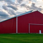 Large red steel building under a dramatic sky