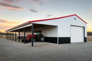 White metal building with an open lean-to addition along its sidewall sheltering equipment